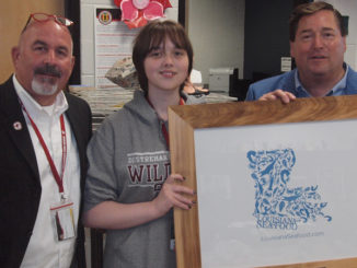 Destrehan High School Principal Stephen Weber, DHS senior Zoe Cloughessy and Louisiana Lt. Governor Billy Nungesser with Cloughessy’s winning logo design.