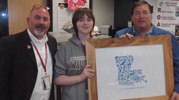 Destrehan High School Principal Stephen Weber, DHS senior Zoe Cloughessy and Louisiana Lt. Governor Billy Nungesser with Cloughessy’s winning logo design.