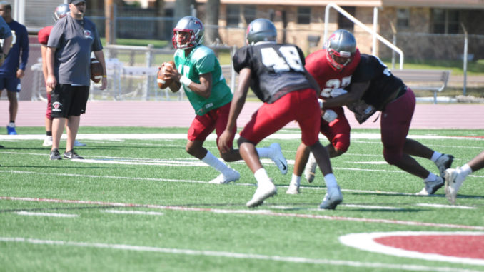DHS’ J.R. Blood rolls out during spring practice.