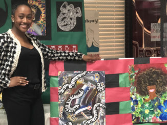 DeJoan Mitchell displaying her art work she did at Destrehan High School.